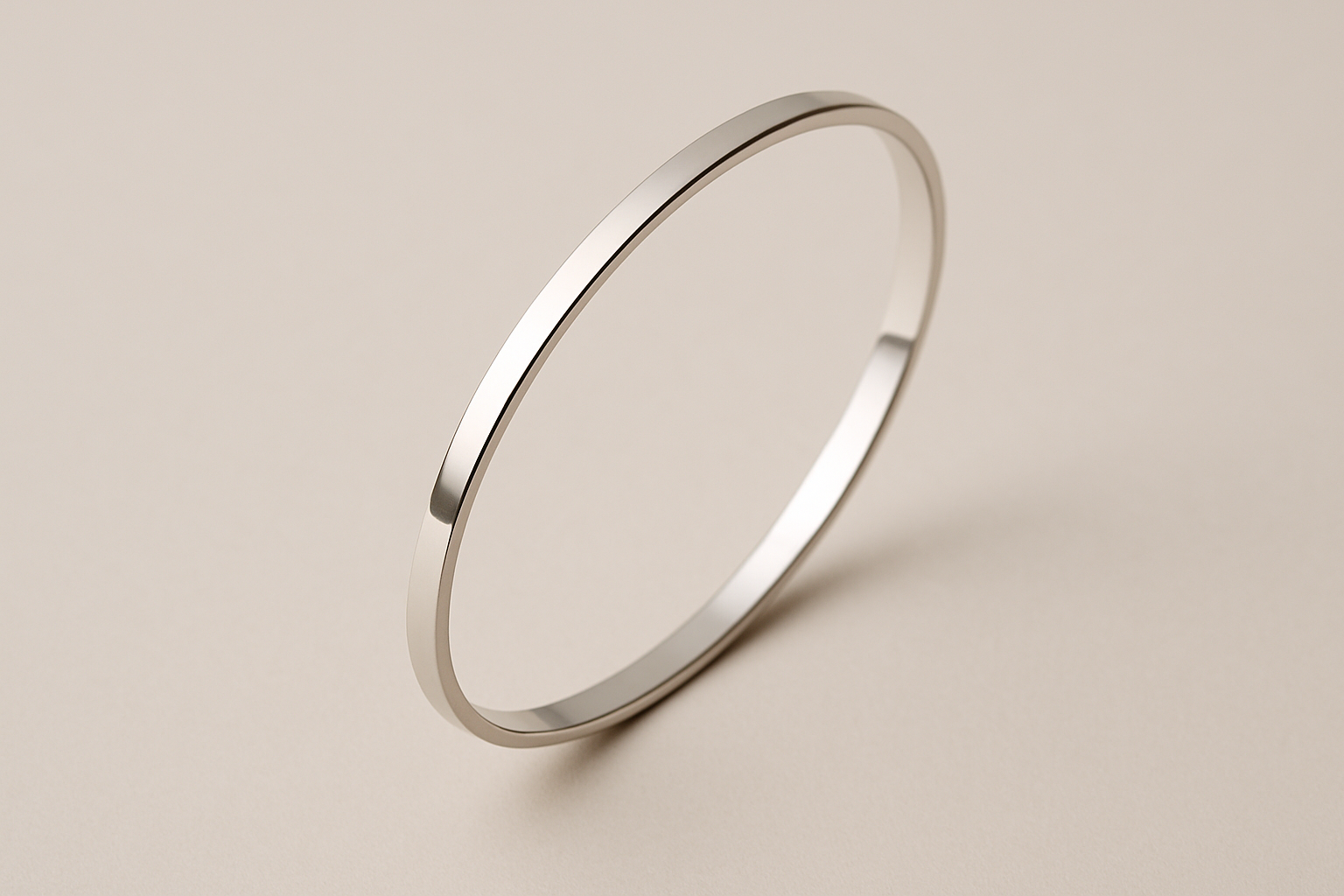 A slim metallic bracelet against a neutral background